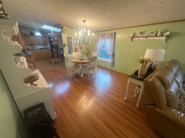 33332 Fern Ct, Lenox, MI 48048 - dining room featuring a textured ceiling, a chandelier, wood finished floors, and crown molding