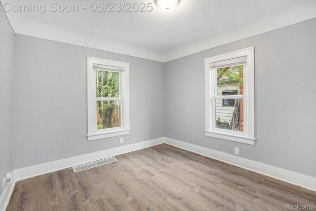 54 Hudson Ave, Pontiac, MI 48342 - spare room featuring healthy amount of natural light, wood finished floors, and baseboards