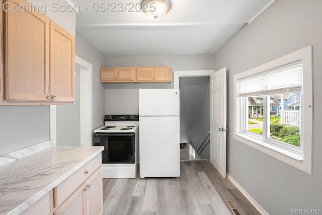 54 Hudson Ave, Pontiac, MI 48342 - kitchen with freestanding refrigerator, electric stove, light brown cabinets, and light wood-type flooring