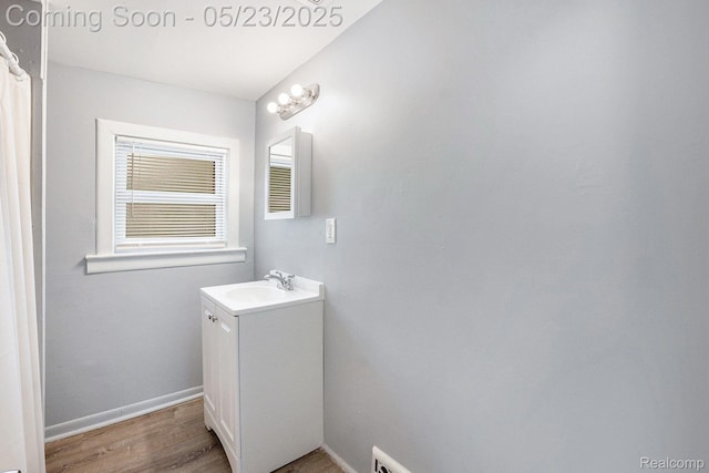54 Hudson Ave, Pontiac, MI 48342 - bathroom featuring vanity, wood finished floors, and baseboards