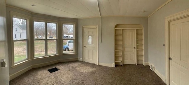 1030 Eastern Ave SE, Grand Rapids, MI 49507 - foyer with ornamental molding, carpet, baseboards, and arched walkways