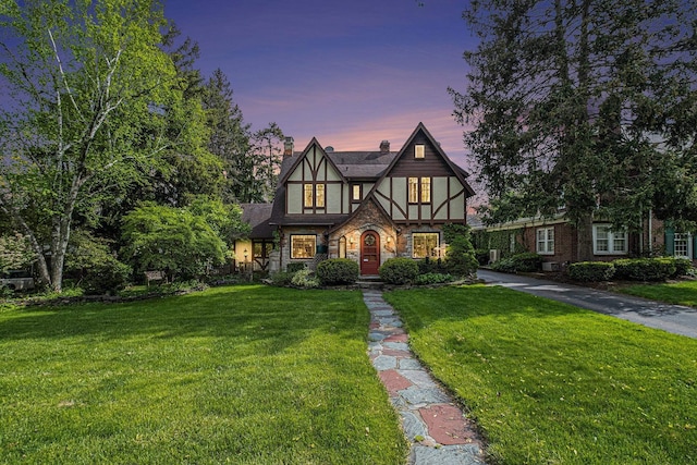 1602 Linwood Ave, Flint, MI 48503 - tudor-style house with a front yard, stucco siding, and stone siding