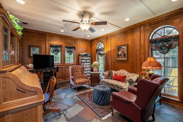 1602 Linwood Ave, Flint, MI 48503 - living area with stone finish floors, a ceiling fan, ornamental molding, wood walls, and recessed lighting