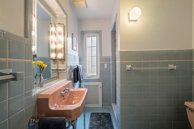 1602 Linwood Ave, Flint, MI 48503 - bathroom featuring tile walls, a wainscoted wall, radiator, tile patterned floors, and a sink