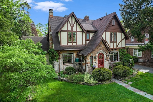 1602 Linwood Ave, Flint, MI 48503 - tudor house with stucco siding, stone siding, and a front yard