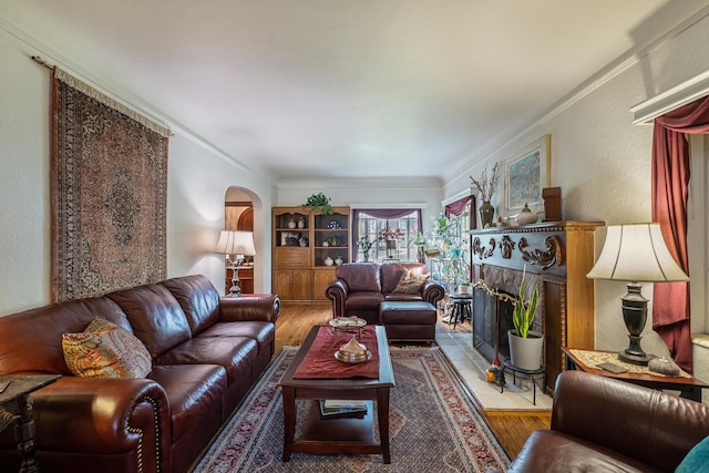 1602 Linwood Ave, Flint, MI 48503 - living room with arched walkways, wood finished floors, crown molding, a fireplace, and a textured wall
