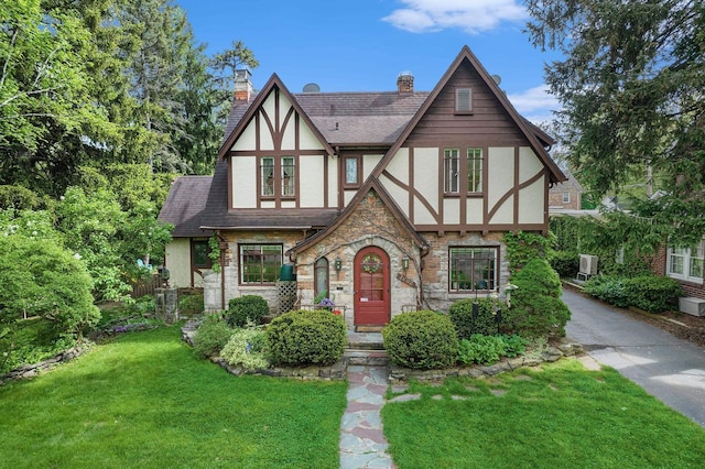 1602 Linwood Ave, Flint, MI 48503 - tudor house featuring stucco siding, stone siding, and a shingled roof
