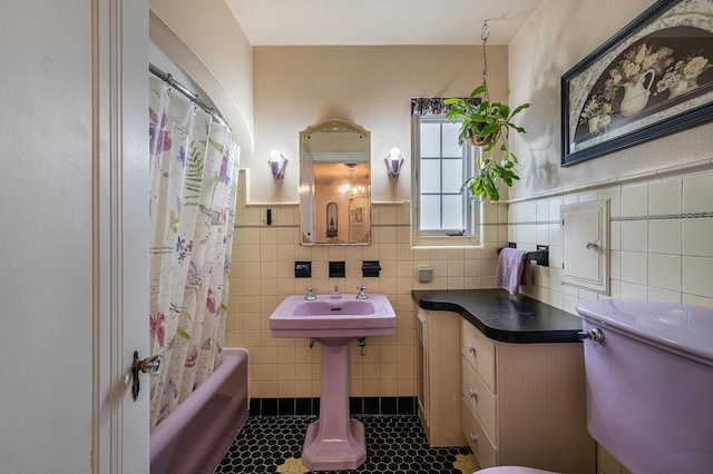 1602 Linwood Ave, Flint, MI 48503 - full bath with tile walls, tile patterned flooring, toilet, shower / bath combination with curtain, and wainscoting