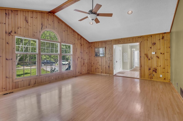 11317 N Dr, Brooklyn, MI 49230 - spare room featuring light wood-style floors, ceiling fan, wood walls, and baseboards