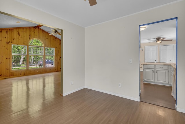 11317 N Dr, Brooklyn, MI 49230 - unfurnished room with ceiling fan, wood finished floors, wood walls, and baseboards