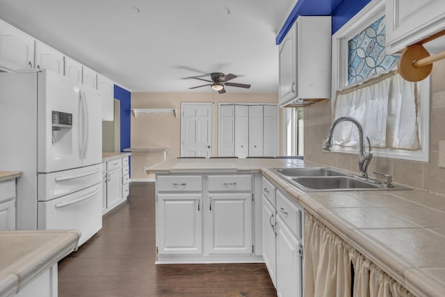 11317 N Dr, Brooklyn, MI 49230 - kitchen with white refrigerator with ice dispenser, a sink, ceiling fan, white cabinetry, and a peninsula