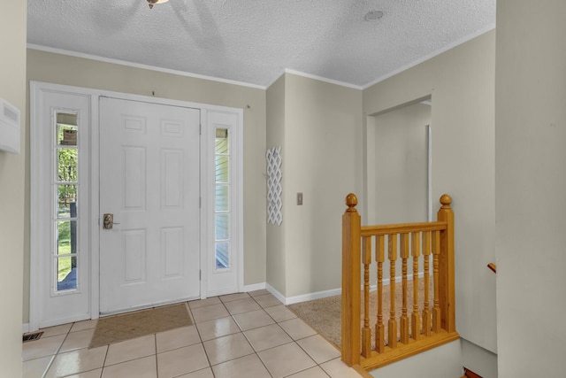 11317 N Dr, Brooklyn, MI 49230 - foyer featuring plenty of natural light, a textured ceiling, light tile patterned flooring, baseboards, and crown molding