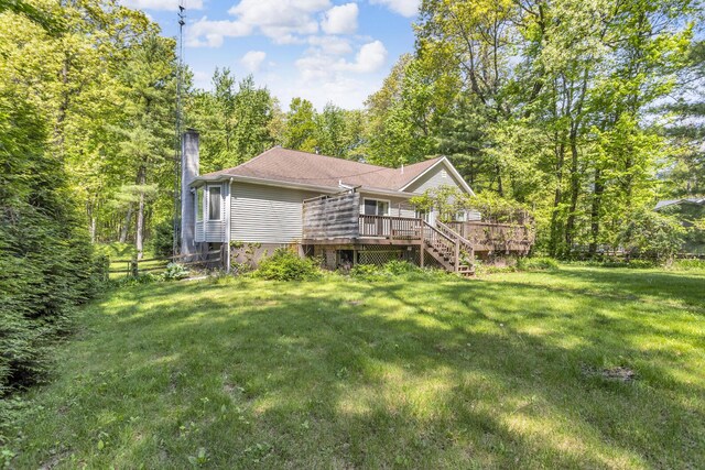 11317 N Dr, Brooklyn, MI 49230 - rear view of property with a chimney, a wooden deck, and a forest view