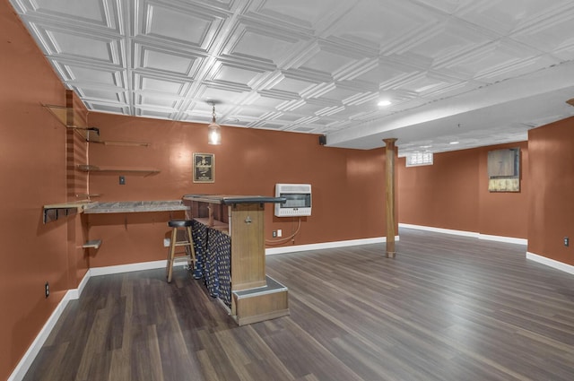 11317 N Dr, Brooklyn, MI 49230 - finished below grade area featuring an ornate ceiling, heating unit, baseboards, dark wood-style flooring, and bar area