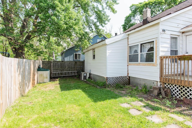 view of yard with a wooden deck and central AC unit