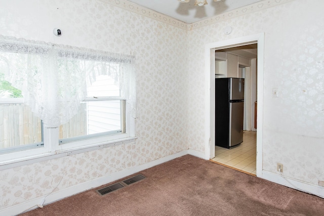empty room featuring carpet flooring, healthy amount of natural light, and baseboards