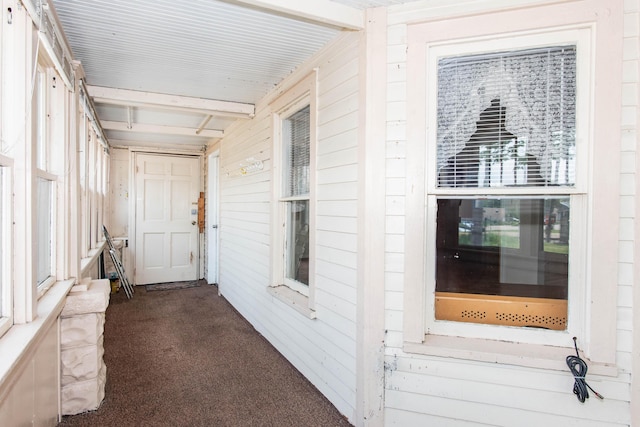 view of exterior entry with a porch