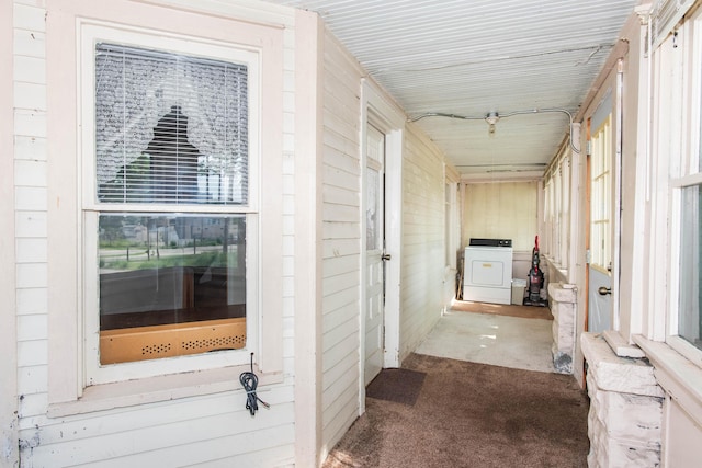 corridor with washer / clothes dryer, carpet flooring, and plenty of natural light