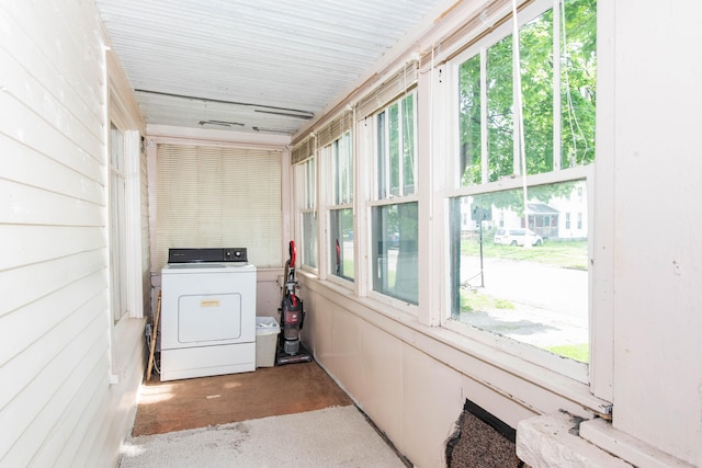 unfurnished sunroom featuring washer / dryer and plenty of natural light