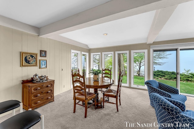 dining room featuring light colored carpet and beam ceiling