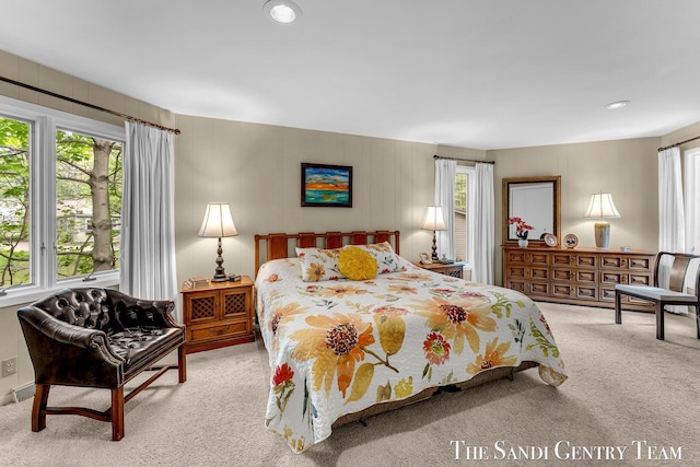 bedroom with carpet and multiple windows
