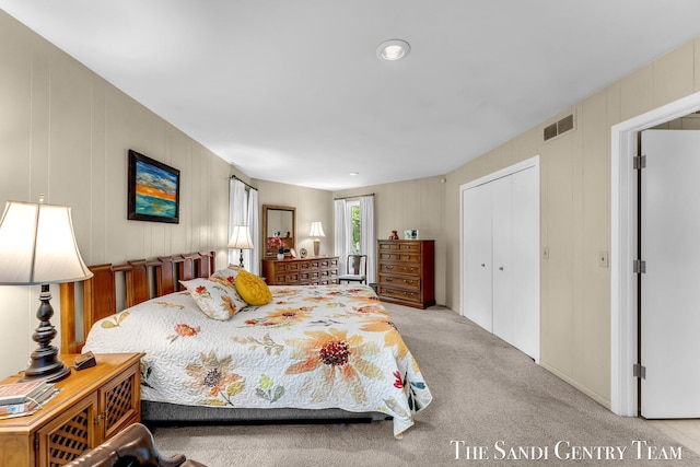 bedroom featuring light colored carpet and a closet