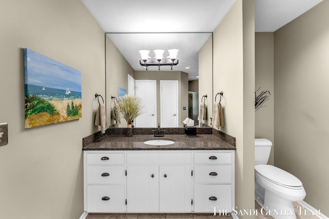 full bathroom featuring toilet, vanity, baseboards, a chandelier, and a stall shower