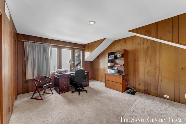 carpeted office featuring wooden walls