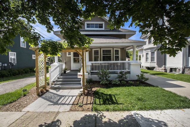 622 Thomas St SE, Grand Rapids, MI 49503 - view of front of house with covered porch, a front lawn, and roof with shingles