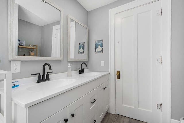622 Thomas St SE, Grand Rapids, MI 49503 - bathroom featuring double vanity and wood finished floors