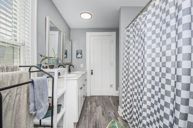 622 Thomas St SE, Grand Rapids, MI 49503 - laundry room featuring cabinet space and dark wood-style flooring