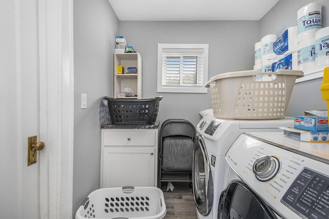 622 Thomas St SE, Grand Rapids, MI 49503 - clothes washing area with washer and clothes dryer, wood finished floors, and cabinet space
