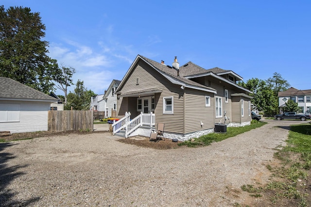 622 Thomas St SE, Grand Rapids, MI 49503 - view of front facade featuring fence, dirt driveway, and a chimney