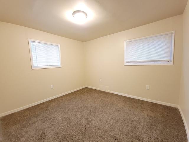 18453 Woodbine St, Detroit, MI 48219 - empty room featuring dark colored carpet and baseboards