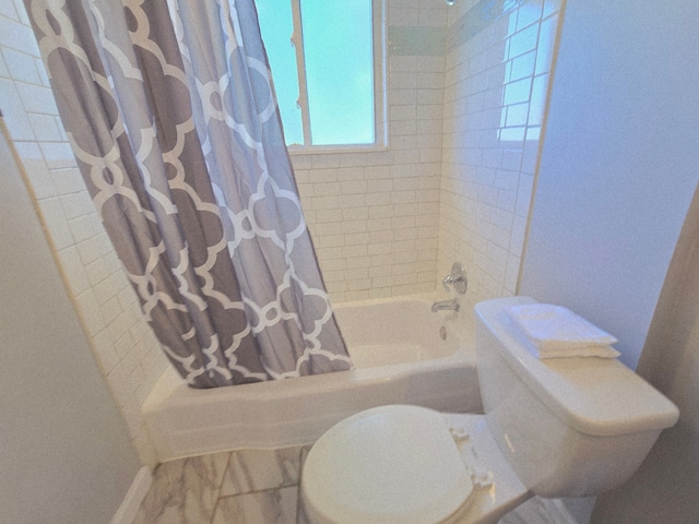 18453 Woodbine St, Detroit, MI 48219 - bathroom featuring shower / tub combo with curtain and toilet