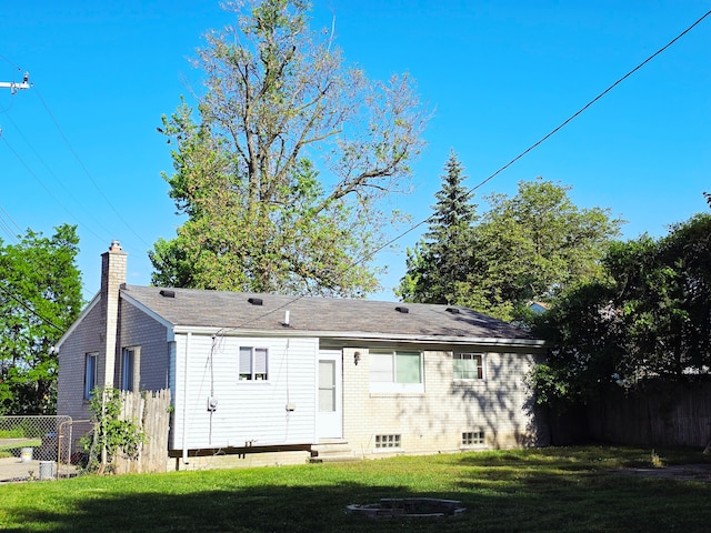 18453 Woodbine St, Detroit, MI 48219 - rear view of property with a chimney, entry steps, and brick siding