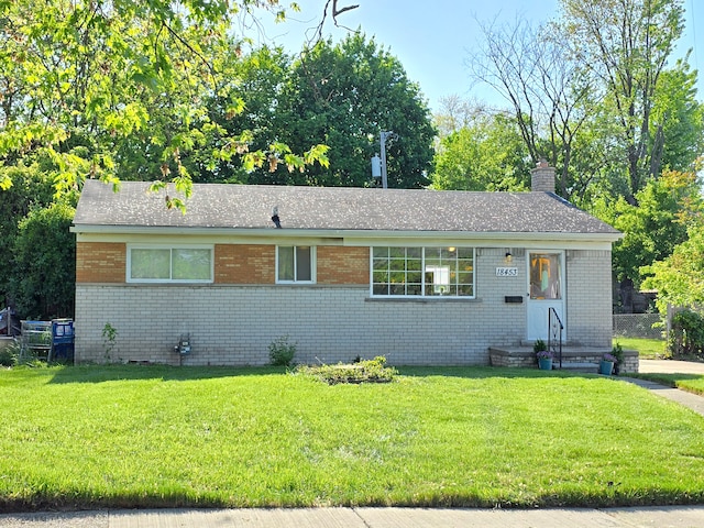 18453 Woodbine St, Detroit, MI 48219 - view of front of house with brick siding, a front lawn, and a chimney