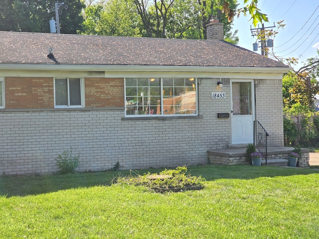 18453 Woodbine St, Detroit, MI 48219 - single story home featuring brick siding, a chimney, and a front yard