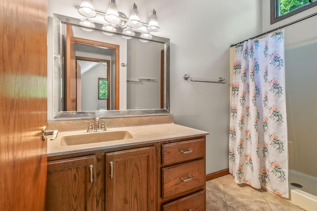 bathroom featuring a stall shower and vanity