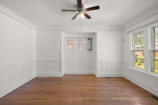 1199 Atkinson St, Detroit, MI 48202 - unfurnished room featuring ceiling fan, a wainscoted wall, ornamental molding, and wood finished floors