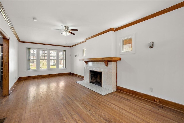1199 Atkinson St, Detroit, MI 48202 - unfurnished living room with a ceiling fan, hardwood / wood-style floors, ornamental molding, baseboards, and a fireplace