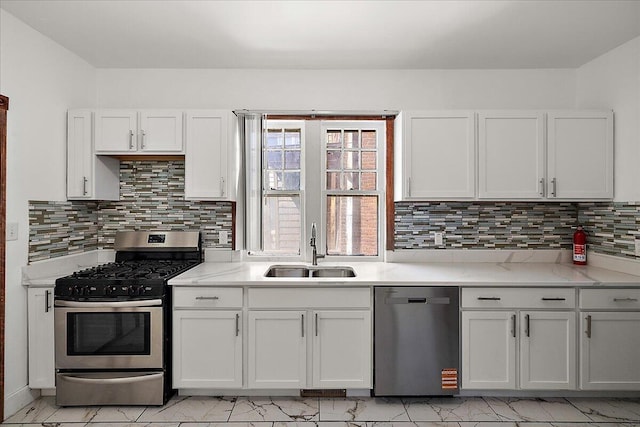 1199 Atkinson St, Detroit, MI 48202 - kitchen with appliances with stainless steel finishes, a sink, white cabinetry, tasteful backsplash, and light stone counters