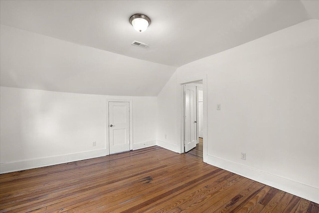 1199 Atkinson St, Detroit, MI 48202 - additional living space with vaulted ceiling, baseboards, and dark wood-style floors