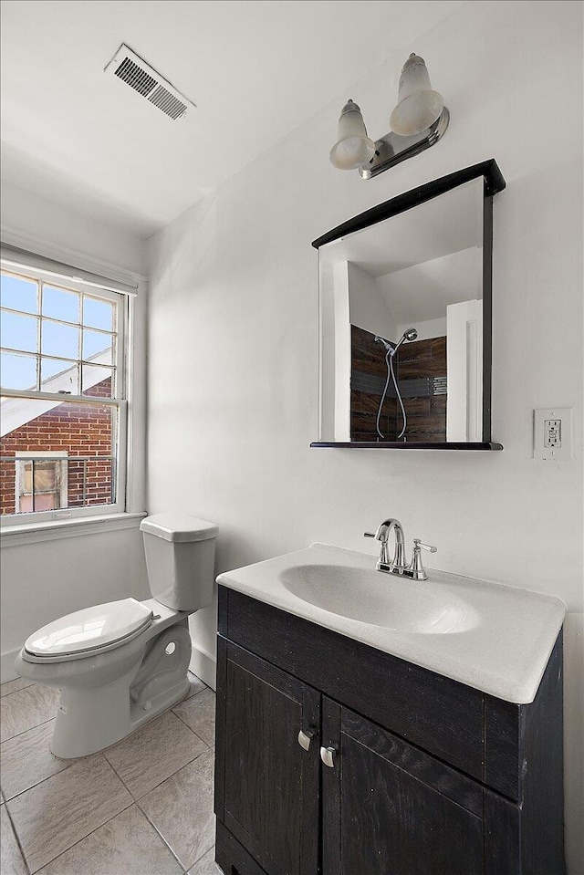 1199 Atkinson St, Detroit, MI 48202 - bathroom featuring toilet, tile patterned flooring, and vanity