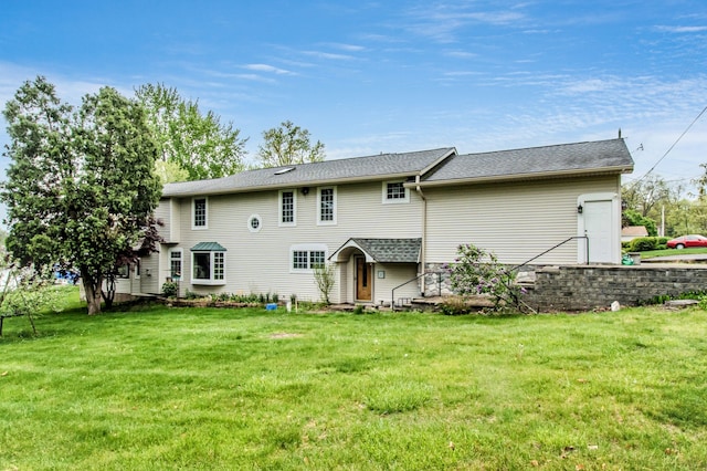 rear view of house with a lawn
