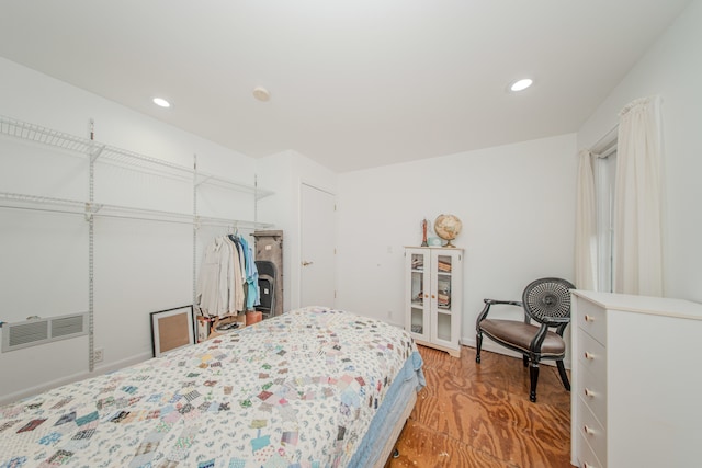 bedroom with recessed lighting and wood finished floors