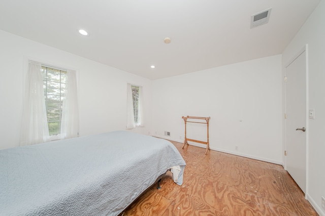 bedroom featuring recessed lighting, baseboards, and light wood-style floors