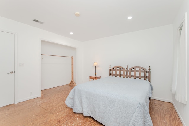 bedroom with light wood finished floors and recessed lighting