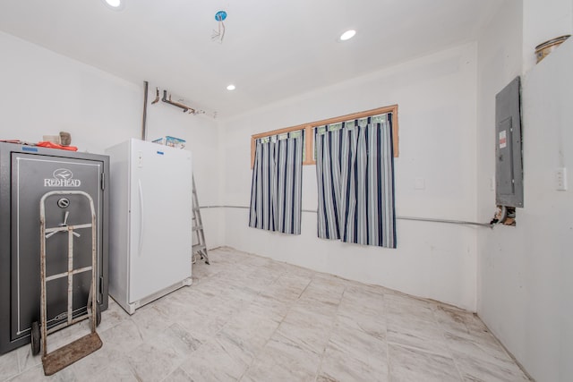 clothes washing area featuring electric panel and recessed lighting