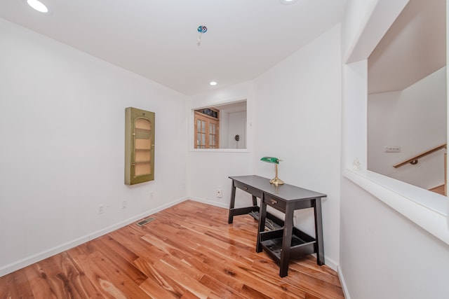 office space featuring light wood-type flooring, recessed lighting, and baseboards